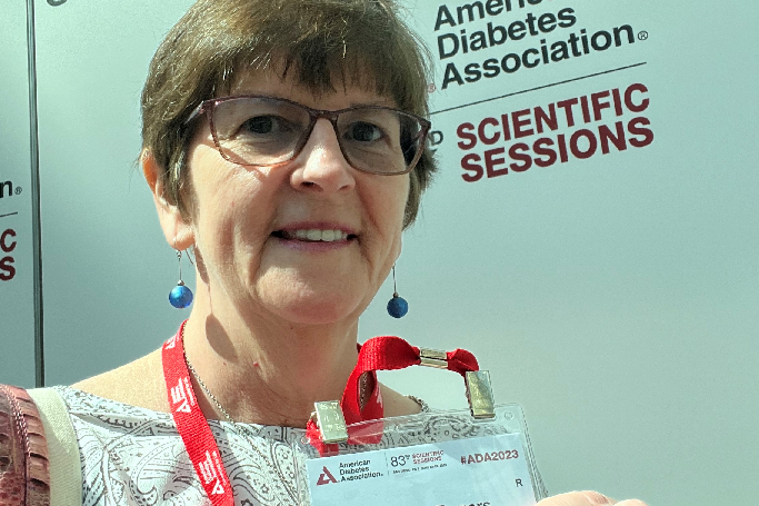 Wendy holding up her badge at the ADA