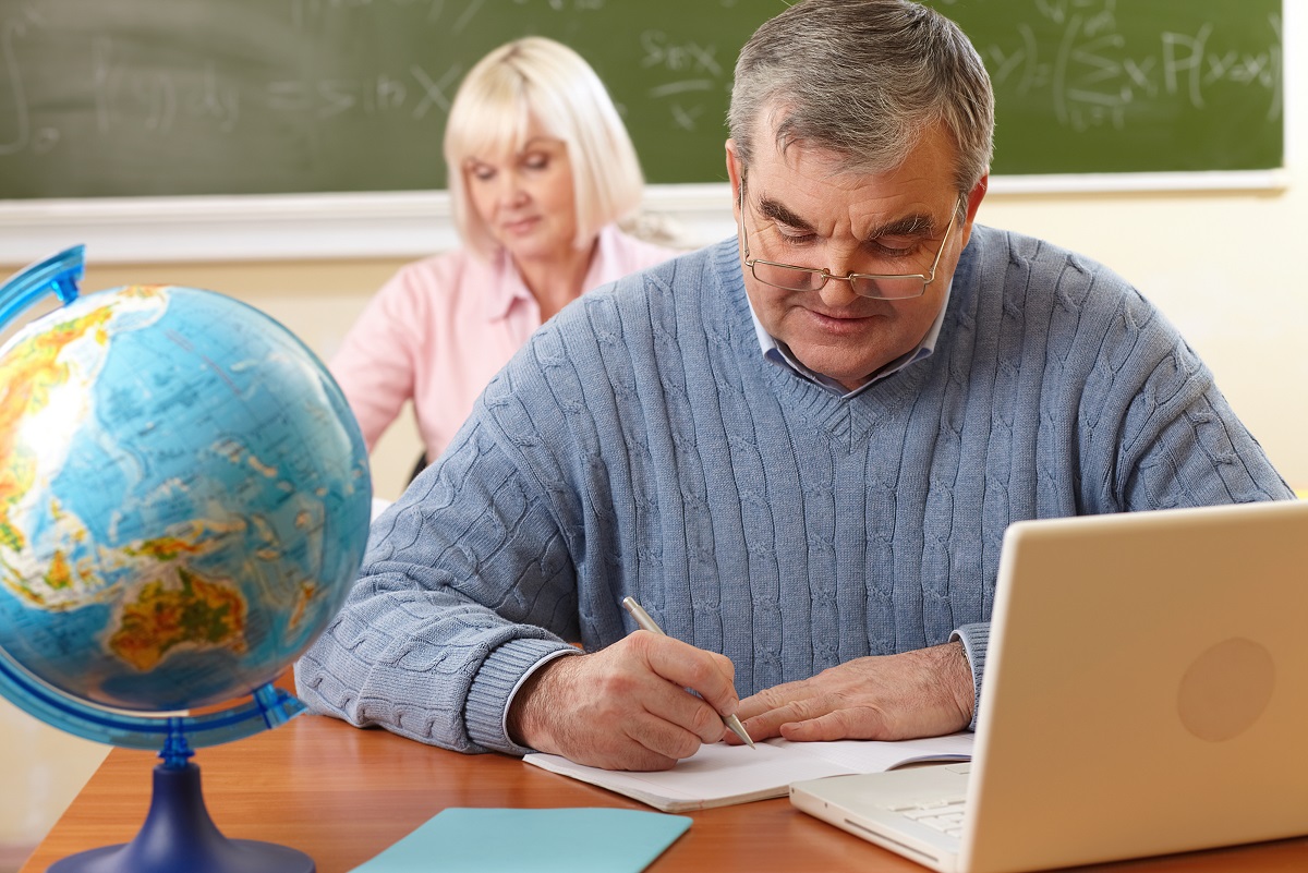 Older male adult taking notes