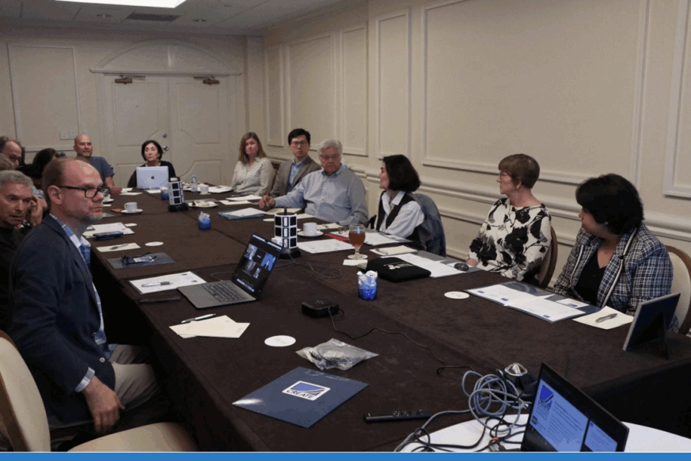 PIs and board members gathered around a table