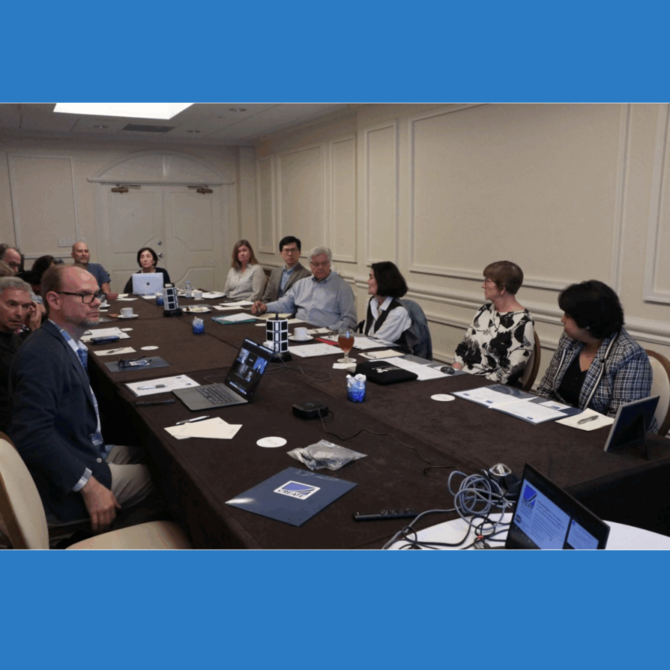 PIs and board members gathered around a table